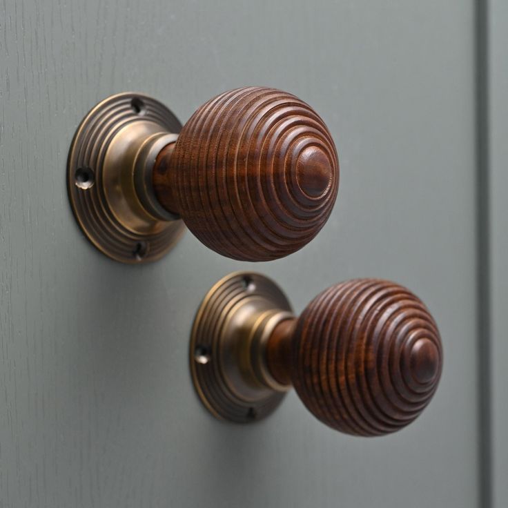 two wooden knobs on the side of a door