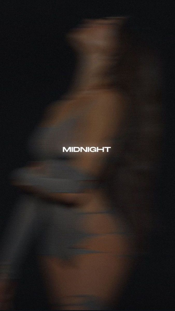 blurry image of the word midnight in front of a blurred woman's torso