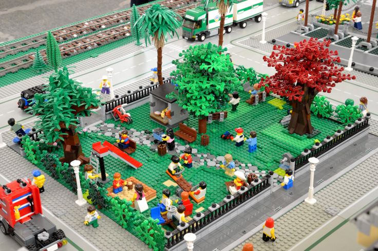 a lego model of a park with trees and people