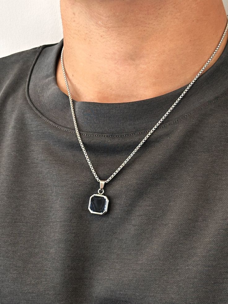 ~Stainless steel pendant - 15x15mm, set with a semi precious jet black Onyx stone. ~Stainless steel chain - 2mm thick. ~Water, Heat, Sweat resistant. ~No discolouration or tarnishing (no green skin). ~Hypoallergenic. ~Reversible pendant, all stainless steel on other side. ~Removable pendant, chain can be worn on its own. Please select chain length from the drop down menu. The length does not include the pendant. I included a picture showing the model (average size young men) wearing 20" and 24" necklaces. Your item will arrive in a drawstring pouch - Ready for Gift Giving! Gunmetal Jewelry With Polished Finish As Gift, Pendants For Men, Gunmetal Jewelry With Polished Finish For Gift, Simple Pendant Necklace Men, Pendant Necklace Men, Silver Stainless Steel Jewelry With Rectangular Pendant, Modern Black Jewelry With Silver Chain, Black Jewelry With Silver Chain And Round Pendant, Stainless Steel Jewelry With Polished Rectangular Pendant