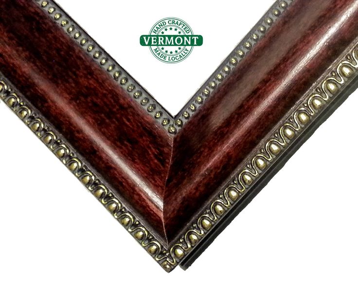 an ornate wooden frame with beading on the edges and bottom, in dark brown