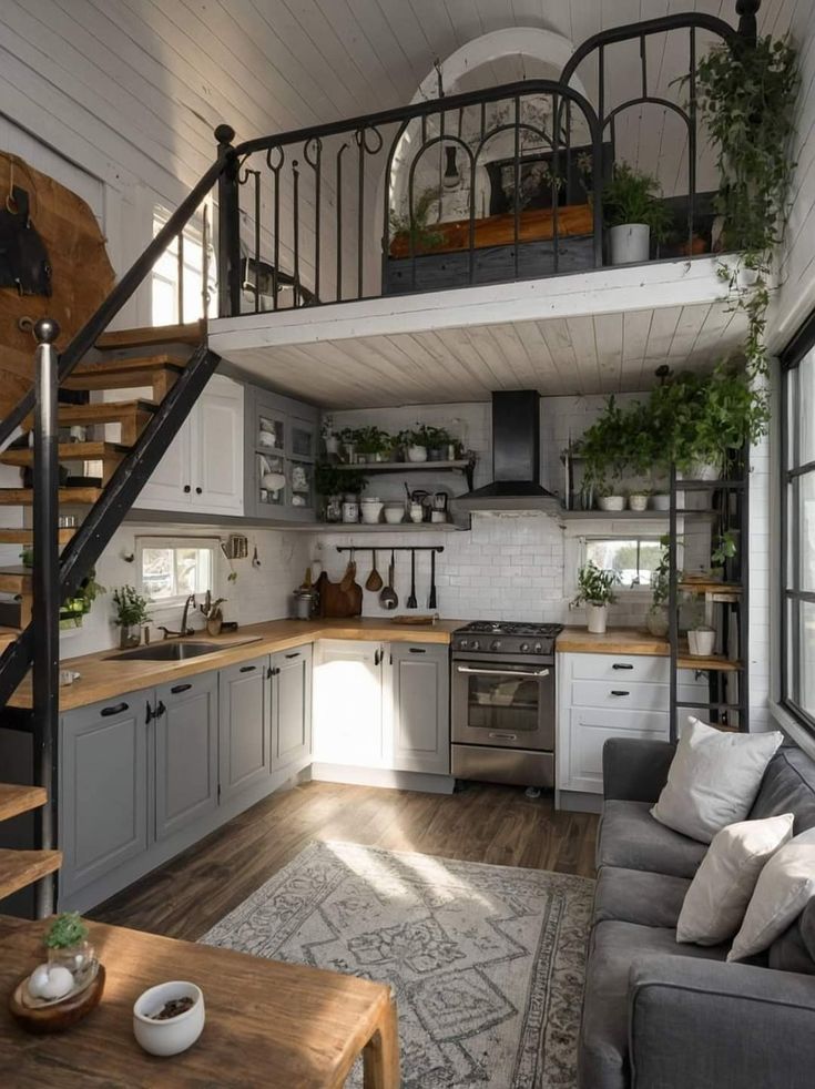 a living room filled with furniture and a spiral staircase leading up to the top floor