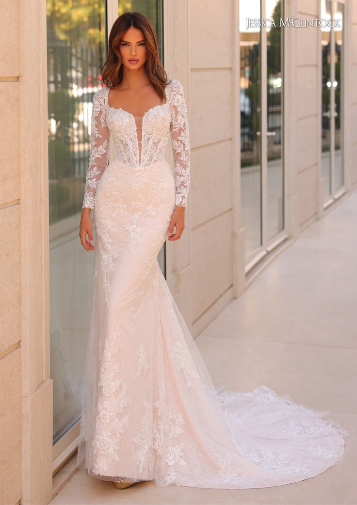 a woman in a wedding dress standing outside