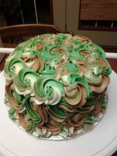 a cake with green and white icing on a table