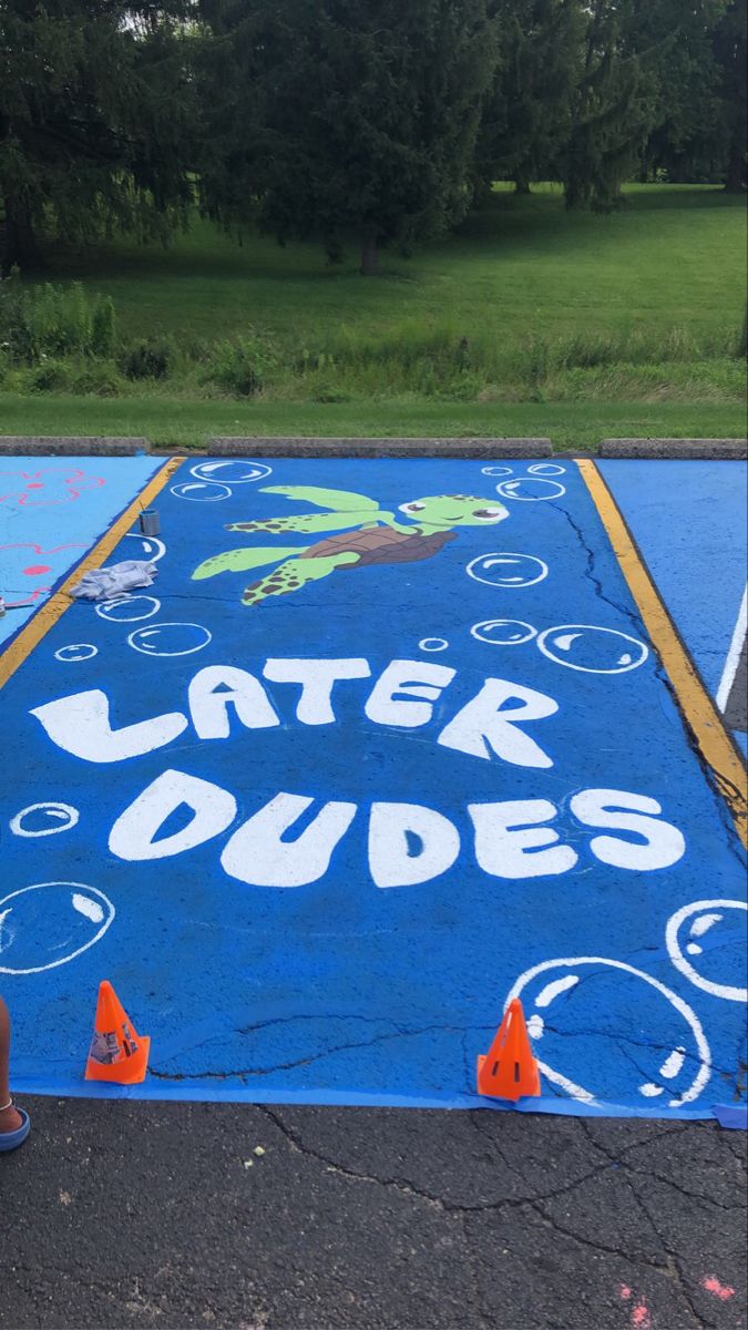 there is a blue and yellow play ground with writing on it that says later dudes