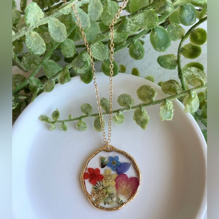 Pressed Wild Flower Necklace | Multi Flower Necklace | Resin Jewelry | Resin Dry Flower Necklace | Resin Dried Flower Necklace Forget Me Not Material: Resin Handmade Item. Materials: 18k Gold Plated Charm: Mix Of Pressed Dried Flowers Circle Charm's Size: 1.19in X 1.19in Heart Charm's Size: 1.57in X 1.18in Necklace's Length: 27in With 3in Extension Please Note That Due To Flower's Color Shade, Lighting Effects, Monitor's Brightness, Contrast And Other Settings, There Might Be Some Slight Differe Resin Necklace With Photo, Resin Pendants Flower, Dry Flower Jewelry, Bohemian Birth Flower Necklaces, Bohemian Gold Flower Necklace, Multicolor Flower Jewelry With Pressed Flowers, Multicolor Flower Shaped Jewelry With Pressed Flowers, Gold Bohemian Flower Necklaces, Bohemian Gold Flower Necklaces