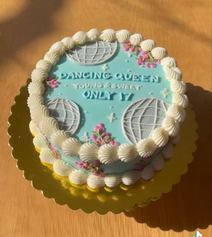 a cake that is sitting on top of a table with the words dancing queen on it