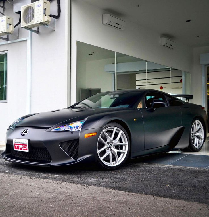 a black sports car parked in front of a building