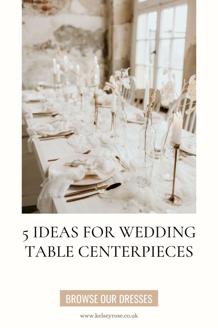 a table with white linens and candles on it