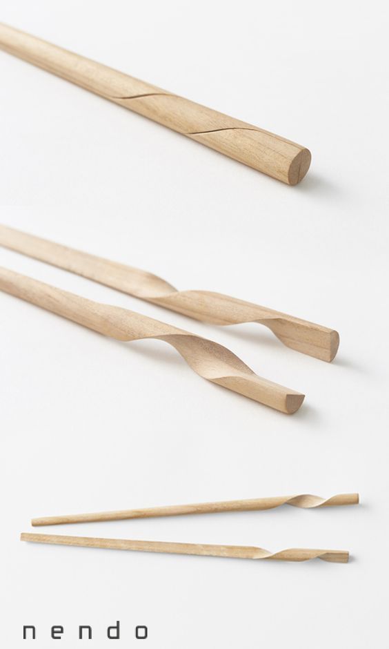 three wooden knitting needles on a white background with the words nendo written below them