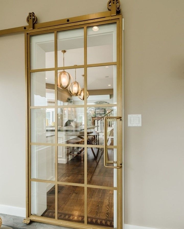 an open glass door leading to a dining room