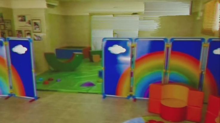 an indoor play area with rainbow painted on the walls