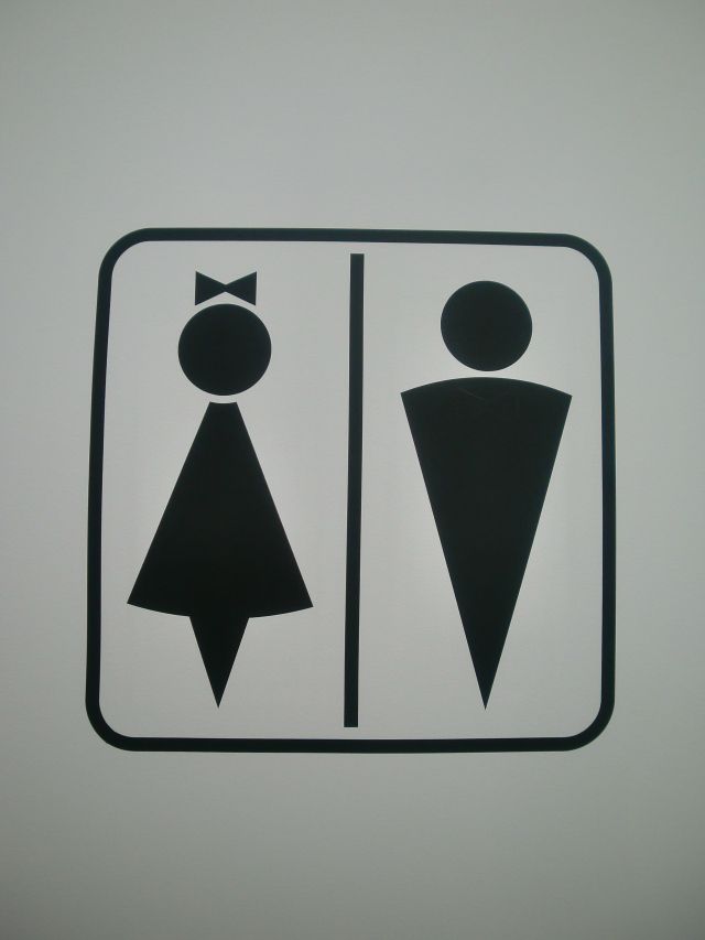 the sign is black and white with an image of two people wearing bow ties on them