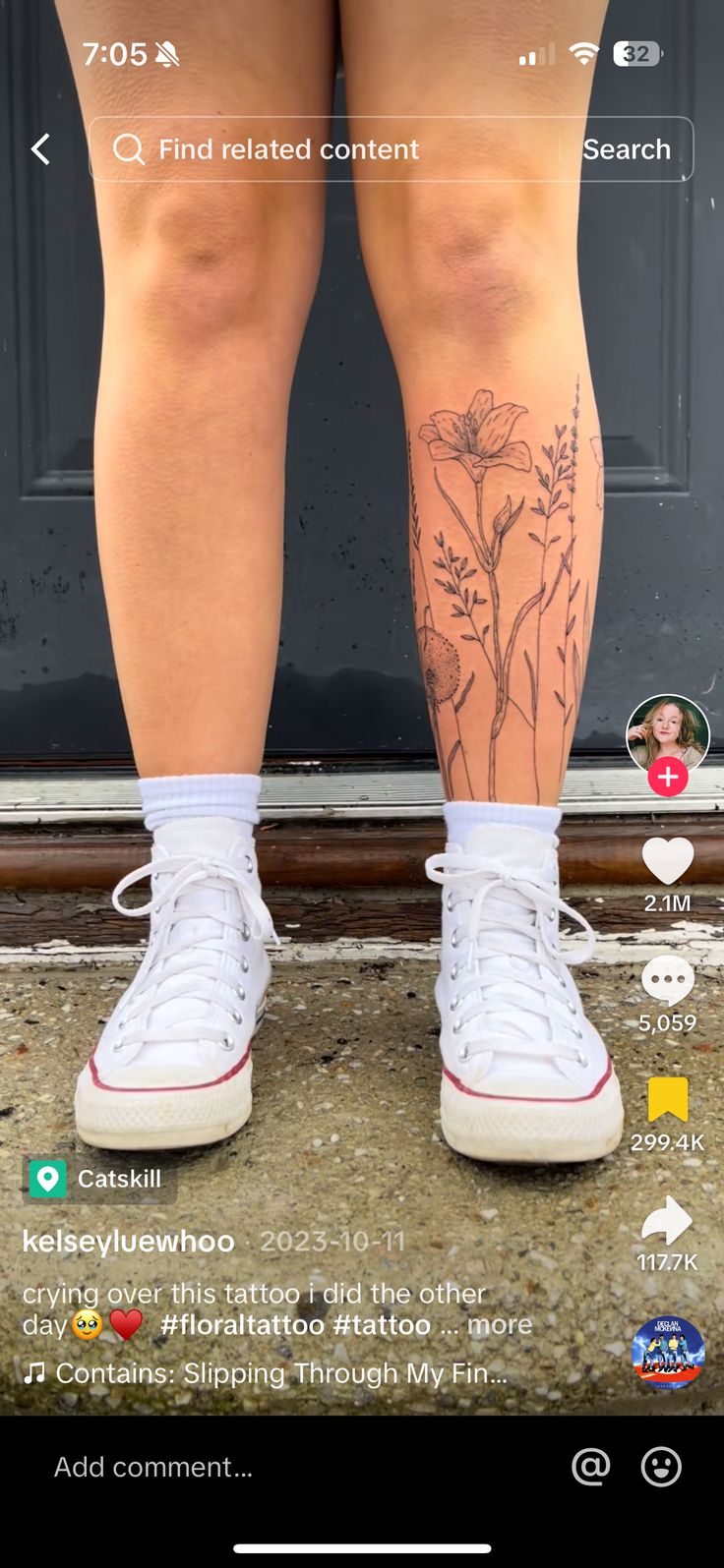 someone with tattoos on their legs standing in front of a door