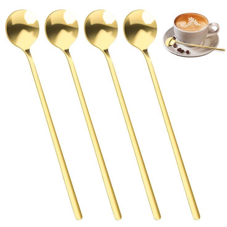 three gold spoons and one coffee cup on a saucer