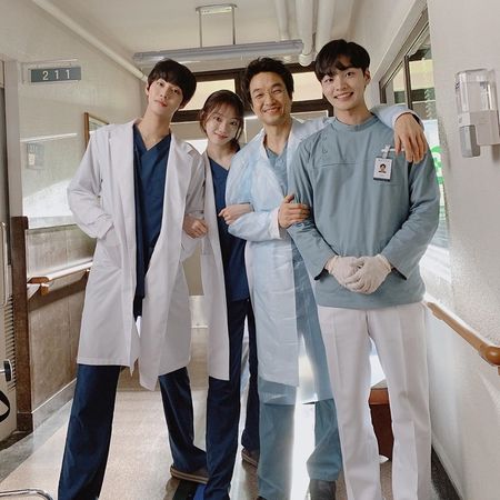 four doctors are posing for a photo in the hallway