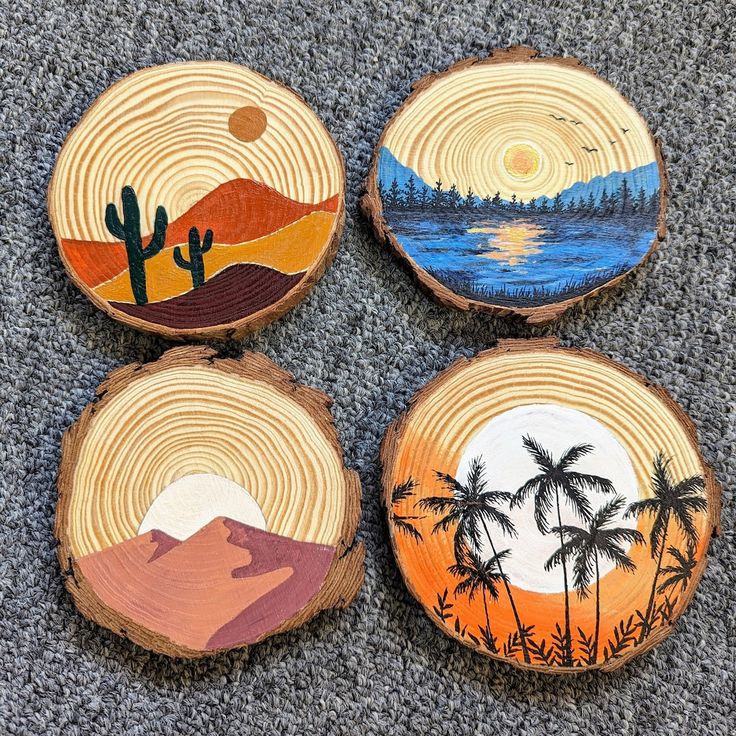 three wood slices with different designs on them sitting on the floor next to each other