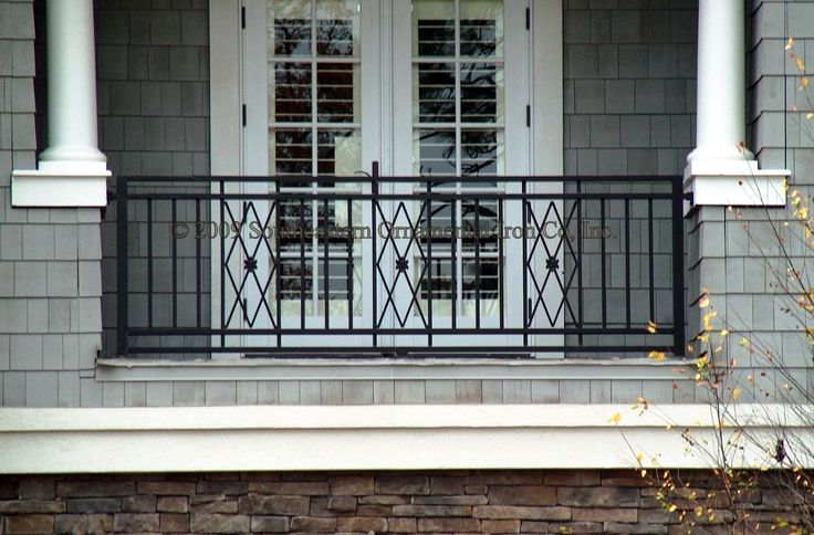 an image of a front porch with wrought iron railing