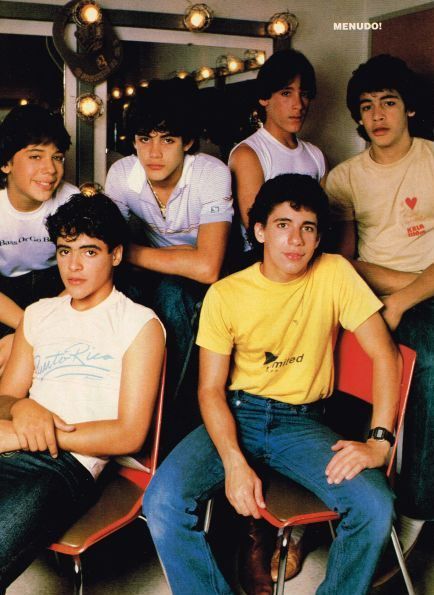 a group of young men sitting next to each other