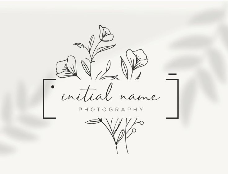 the logo for a photography studio with flowers and leaves in black on a white background