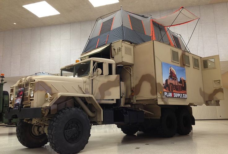 an army truck parked in a large building