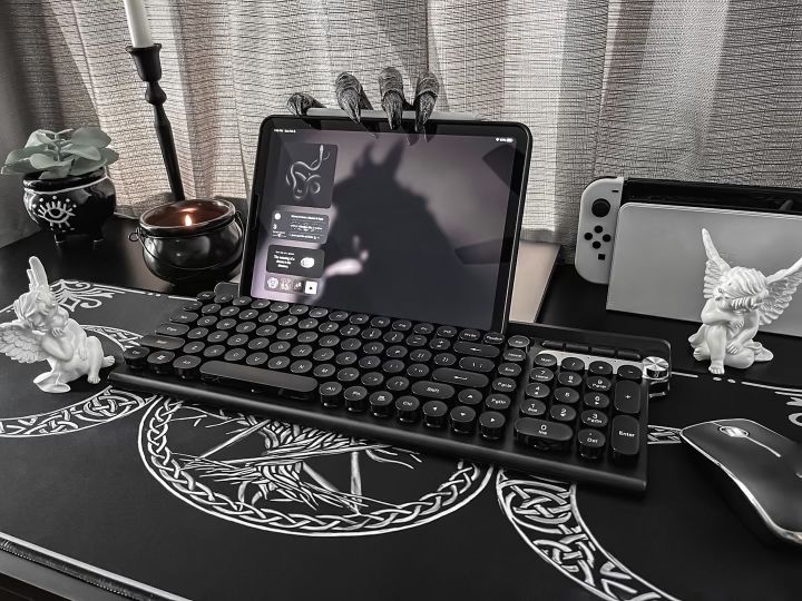 a computer keyboard sitting on top of a desk next to a mouse and cell phone