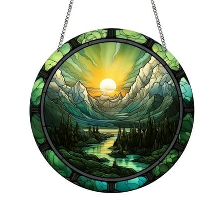 a round stained glass window with mountains and trees in the background, hanging from a chain