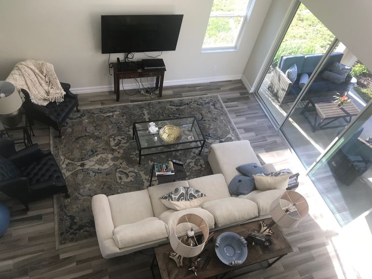 an aerial view of a living room with couches, chairs and a flat screen tv