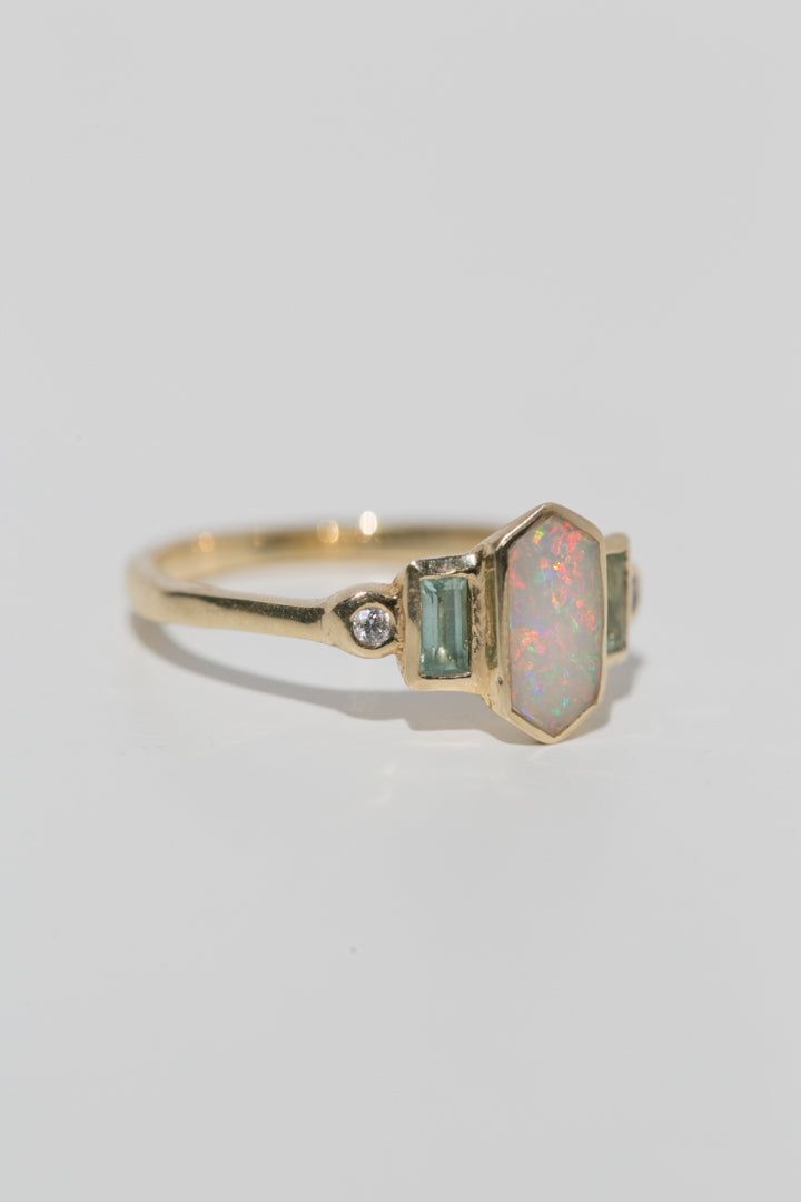 Art deco inspired ring with Australian opal, with either aquamarine and diamonds, or rubies. The opal is inlaid into the elongated hexagon, measuring 9.5mm x 5mm. Accent aquamarine and diamonds are approximately .30 total carat worth. Millimeter measurement from end to end is 15mm. Your choice of gold color and karat. The band is 1.75mm thick. Please leave a note at checkout with your preferred size. All gems and rocks are nuanced in color, please know that your ring will be very similar to the Opal Accent Engagement Ring, Inlaid Opal Ring, Opal Diamond Ring Engagement, Hexagon Opal Ring, Aquamarine Opal Engagement Ring, Diamond Opal Ring, Opal Engagement Ring White Gold, Opal And Aquamarine Ring, Art Deco Opal Ring