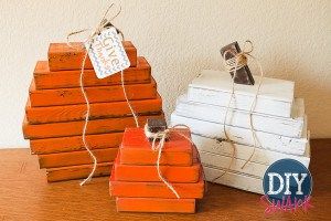 two small wooden boxes sitting on top of a table next to each other with tags hanging from them