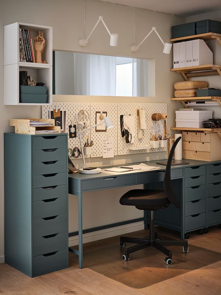 a home office area with desk, filing cabinets and shelves on either side of the room