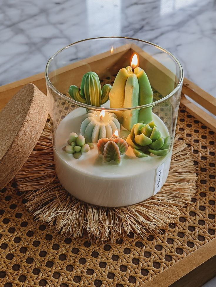 a glass bowl filled with candles on top of a table