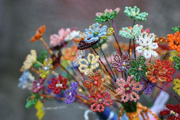 a vase filled with colorful flowers on top of a table