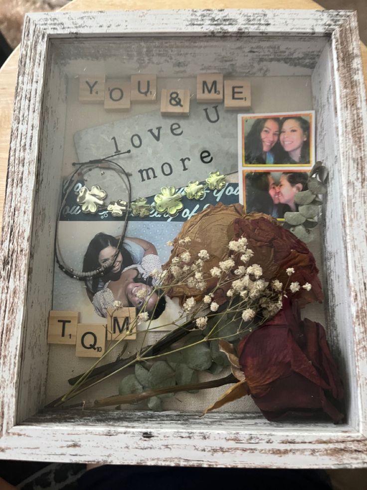 an old frame with flowers and pictures in it that says you & me love is more