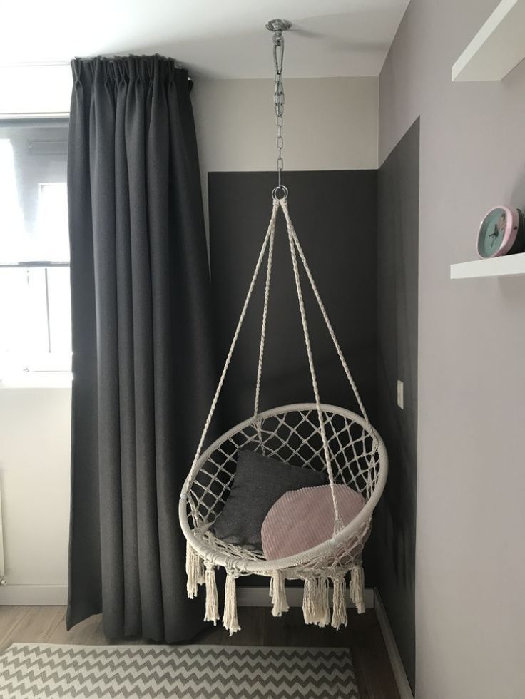 a hammock hanging from the ceiling in a room with black and white walls