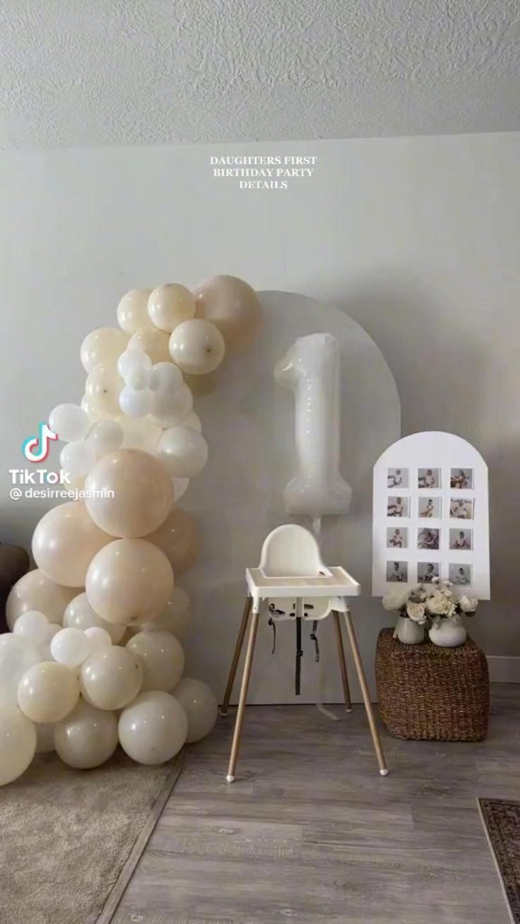 the balloon arch is decorated with white balloons