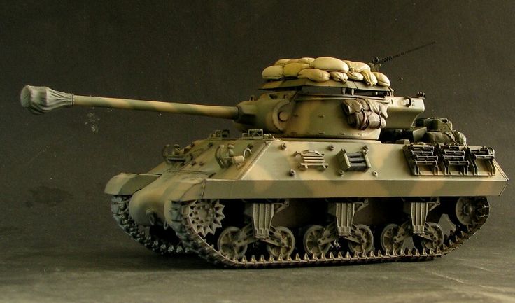 a toy tank with some bread on it's top sitting on a table in front of a black background