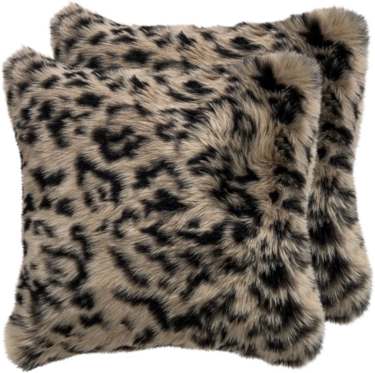 an animal print pillow with black and white spots on it's fur, against a white background