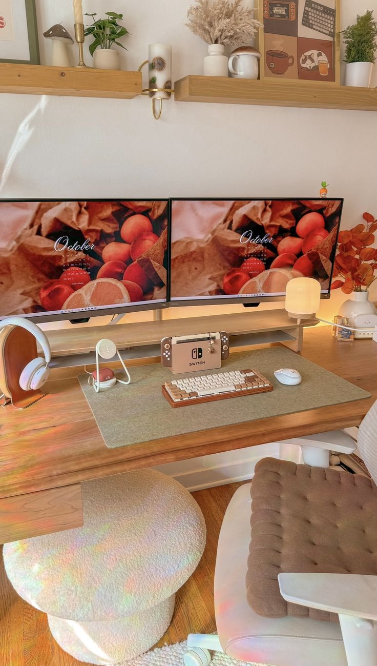 two televisions sitting on top of a wooden desk next to a chair and ottoman