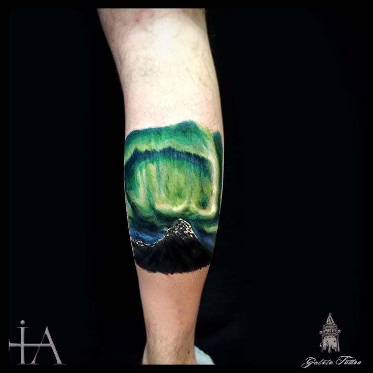 a man's arm with an aurora bore tattoo on it