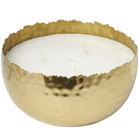 a gold metal bowl with a white candle inside