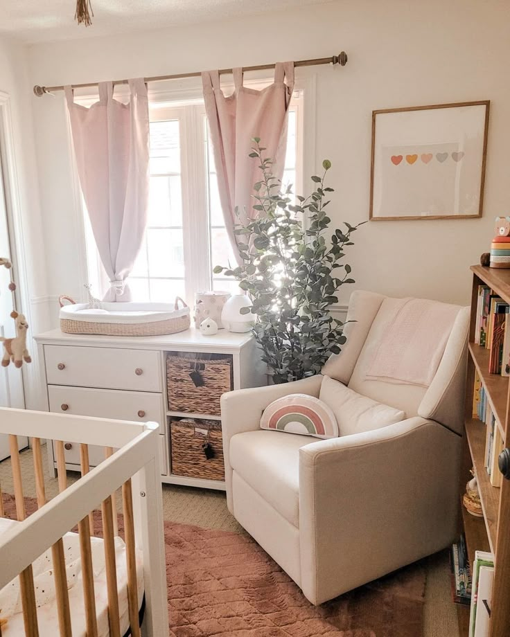 a baby's room with a crib, dresser and chair in it is shown