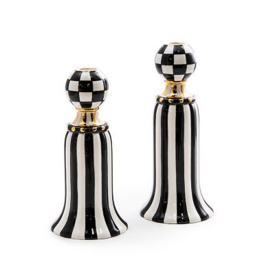 two black and white salt and pepper shakers with gold trimmings on them