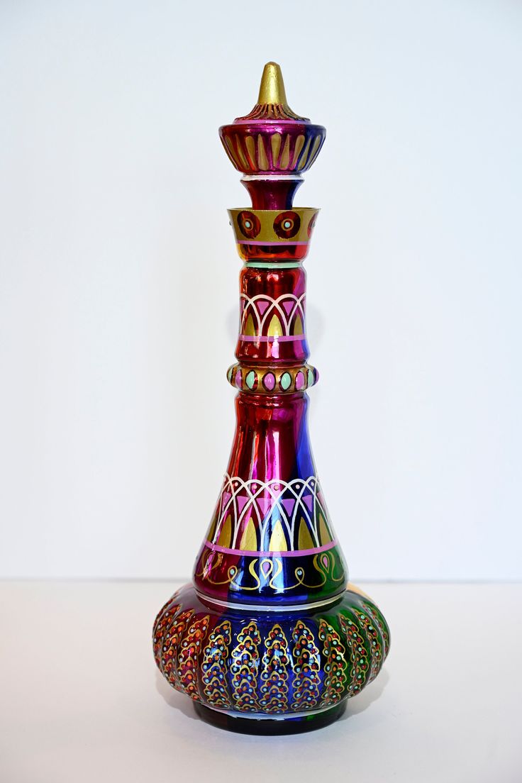 a multicolored vase sitting on top of a table