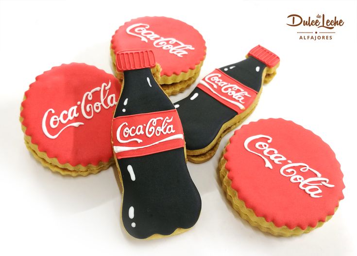 coca - cola cookies are decorated with royal icing and black frosting, along with two coke bottle caps