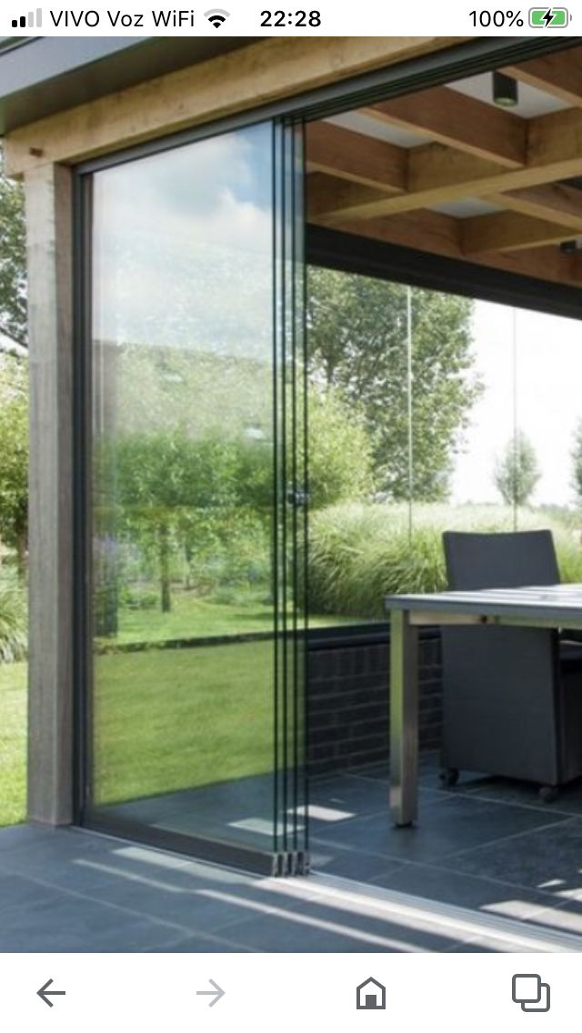 an outdoor dining area with sliding glass doors on the outside, and a patio in the background