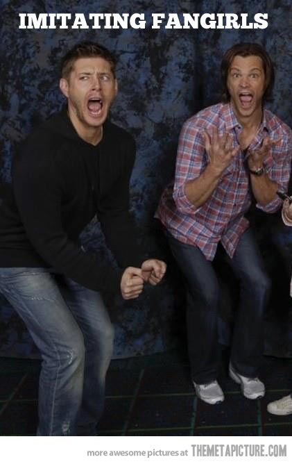 three men posing for the camera with their hands in the air and one holding his mouth open