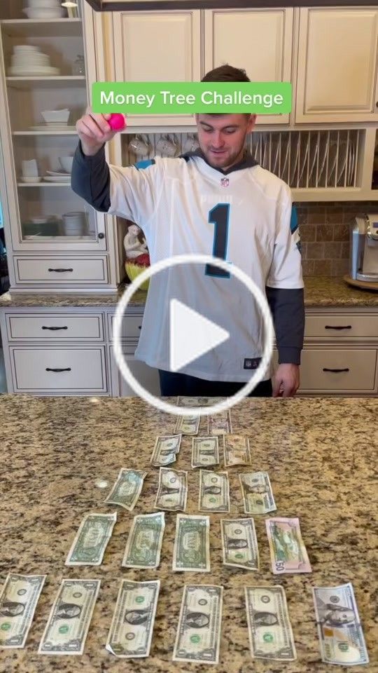 a man standing in front of a kitchen counter with money on it and the words money tree challenge