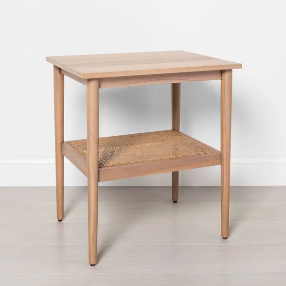 a small wooden table with one shelf on the side and two drawers on the top