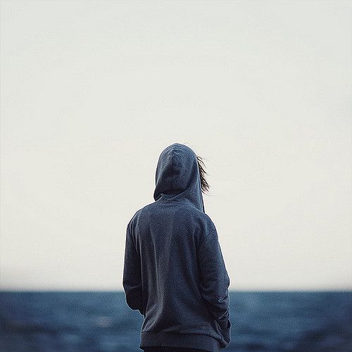 a person standing in front of the ocean